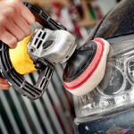 Car headlight cleaning with power buffer machine at service station